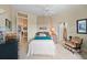 Guest bedroom with teal bedding and ensuite bath at 213 The Esplanade S, Venice, FL 34285
