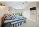 Bright bedroom with striped bedding and ocean view at 213 The Esplanade S, Venice, FL 34285
