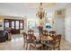 Elegant dining room with a large table and chandelier at 213 The Esplanade S, Venice, FL 34285