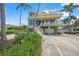 Beautiful beachfront home with palm trees and circular driveway at 213 The Esplanade S, Venice, FL 34285