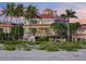 Beachfront home with palm trees, circular driveway, and stunning sunset views at 213 The Esplanade S, Venice, FL 34285