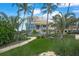 Luxury home with palm trees, manicured lawn, and walkway at 213 The Esplanade S, Venice, FL 34285