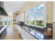 Ocean view kitchen, granite countertops, white cabinets, and stainless steel appliances at 213 The Esplanade S, Venice, FL 34285