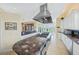 Gourmet kitchen with island, stainless steel appliances, and granite countertops at 213 The Esplanade S, Venice, FL 34285