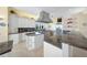 Spacious kitchen with granite countertops and stainless steel appliances at 213 The Esplanade S, Venice, FL 34285