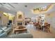 Open concept living and dining area with a fireplace and high ceilings at 213 The Esplanade S, Venice, FL 34285