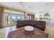 Ocean-view living room with leather sectional sofa and fireplace at 213 The Esplanade S, Venice, FL 34285
