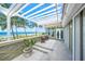 Covered patio with ocean view and comfortable seating at 213 The Esplanade S, Venice, FL 34285