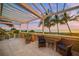 Relaxing oceanfront patio with pergola and seating at 213 The Esplanade S, Venice, FL 34285