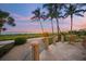 Relaxing ocean view patio with seating and glass railings at 213 The Esplanade S, Venice, FL 34285