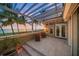 Oceanfront patio with pergola, wicker chairs and sunset views at 213 The Esplanade S, Venice, FL 34285