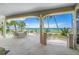 Covered patio with ocean view and seating for six at 213 The Esplanade S, Venice, FL 34285