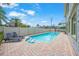 Inviting heated pool with brick patio and lounge chairs at 213 The Esplanade S, Venice, FL 34285