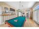 Game room features a pool table and bar area at 213 The Esplanade S, Venice, FL 34285