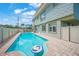 Heated pool with a dolphin mosaic and brick patio at 213 The Esplanade S, Venice, FL 34285