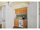 Convenient wet bar with sink, mini-fridge, and cabinets at 213 The Esplanade S, Venice, FL 34285