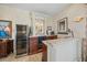 Wet bar with wine cooler, granite countertop, and cabinetry at 213 The Esplanade S, Venice, FL 34285