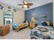 Twin bedroom with two beds, ceiling fan, and nautical-themed decor at 224 Ariano Ave, Nokomis, FL 34275