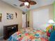 Bedroom with a queen bed, ceiling fan, and tropical decor at 224 Ariano Ave, Nokomis, FL 34275