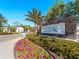 Community entrance sign with landscaping and a gated entrance at 224 Ariano Ave, Nokomis, FL 34275