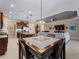 Kitchen and dining area with tile floors and a large table at 224 Ariano Ave, Nokomis, FL 34275