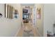Hallway with view into living area, mirrors, and decor at 224 Ariano Ave, Nokomis, FL 34275