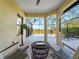 Relaxing lanai with pool view, wicker furniture, and tropical decor at 224 Ariano Ave, Nokomis, FL 34275