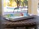 Close-up of a tropical-themed tray on a wicker table at 224 Ariano Ave, Nokomis, FL 34275