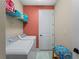 Laundry room with washer, dryer, and shelving for storage at 224 Ariano Ave, Nokomis, FL 34275