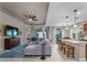 Open living room, kitchen, and dining area with a large sectional sofa and island at 224 Ariano Ave, Nokomis, FL 34275