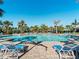 Refreshing community pool surrounded by lush landscaping at 224 Ariano Ave, Nokomis, FL 34275