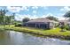 Back of house boasts a large pool and canal views at 256 Royal Oak Way, Venice, FL 34292