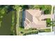 Bird's-eye view of single-Gathering home with pool and canal at 256 Royal Oak Way, Venice, FL 34292