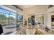 Breakfast nook with glass table and wicker chairs, overlooking the pool and lake at 256 Royal Oak Way, Venice, FL 34292