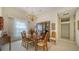 Bright dining room featuring a formal dining table and elegant chandelier at 256 Royal Oak Way, Venice, FL 34292
