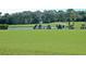 Driving range at a golf course with golfers at 256 Royal Oak Way, Venice, FL 34292