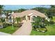 Luxury home with tile roof, paver driveway & lush landscaping at 256 Royal Oak Way, Venice, FL 34292