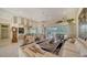 Open living room showcasing a large seating area and views of the backyard at 256 Royal Oak Way, Venice, FL 34292