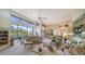 Spacious living room with fireplace, large windows, and plenty of natural light at 256 Royal Oak Way, Venice, FL 34292