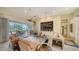 Spacious living room with ample natural light and access to a relaxing patio at 256 Royal Oak Way, Venice, FL 34292