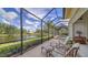 Large screened-in patio with pool and lake view at 256 Royal Oak Way, Venice, FL 34292