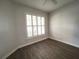 Bright bedroom with wood-look flooring and plantation shutters at 2890 Whispering Pine Ln, North Port, FL 34287