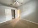Bedroom with carpeted floor, ceiling fan, and a closet at 2890 Whispering Pine Ln, North Port, FL 34287