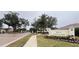 Gated community entrance to Villas at Charleston Park with landscaped grounds at 2890 Whispering Pine Ln, North Port, FL 34287
