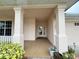 Covered front porch with tiled flooring and columns at 2890 Whispering Pine Ln, North Port, FL 34287