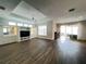 Spacious living room with hardwood floors and lots of natural light at 2890 Whispering Pine Ln, North Port, FL 34287