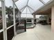 Relaxing screened lanai with hot tub and lake view at 2890 Whispering Pine Ln, North Port, FL 34287