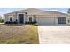 Single-story house with attached garage and landscaping at 2949 Jaylene Rd, North Port, FL 34288