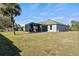Single-story house with a screened patio and large backyard at 2949 Jaylene Rd, North Port, FL 34288