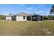 Single-story house with a screened patio and large backyard at 2949 Jaylene Rd, North Port, FL 34288
